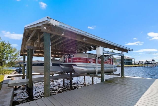 dock area with boat lift and a water view