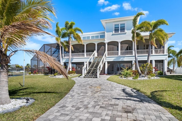 view of building exterior with decorative driveway and stairway