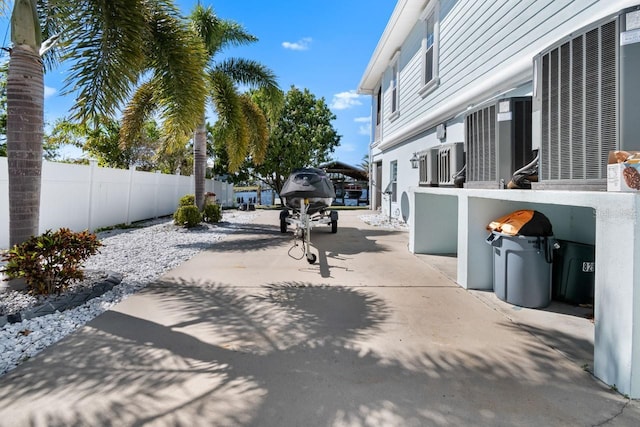 view of yard with central AC unit and fence