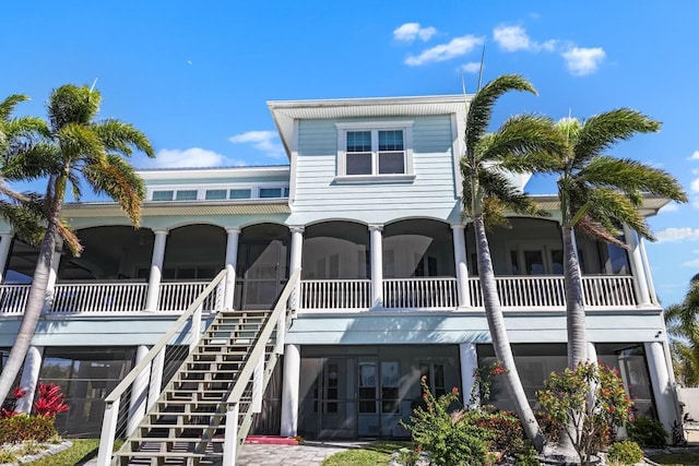 rear view of property with stairway