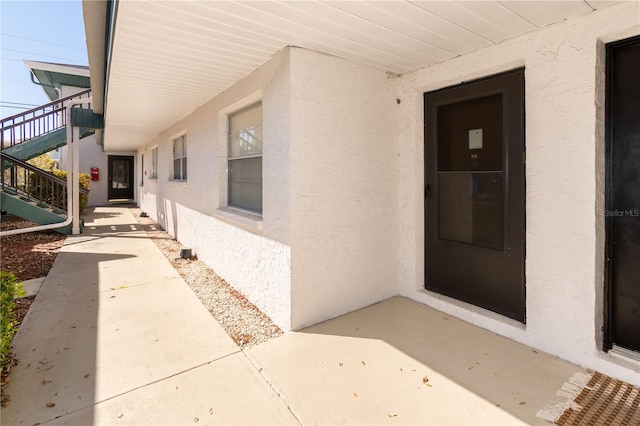 property entrance featuring stucco siding