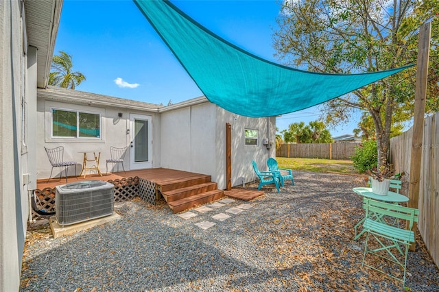 view of patio with a fenced backyard, a deck, and central air condition unit