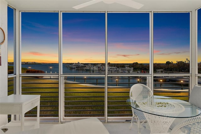 unfurnished sunroom with a water view