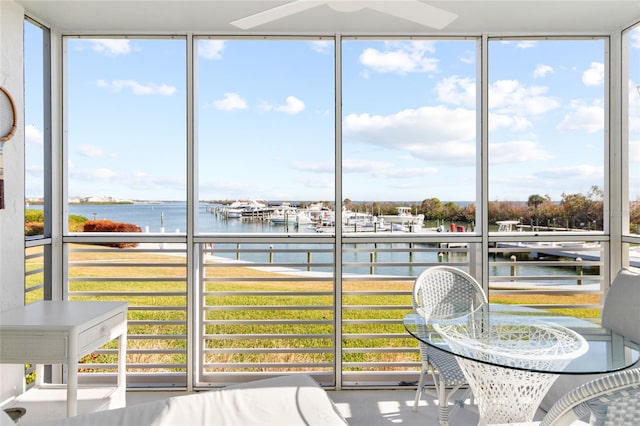 unfurnished sunroom featuring a water view