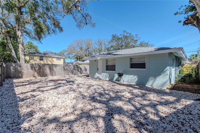 rear view of house with a fenced backyard