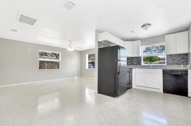 kitchen with light speckled floor, open floor plan, a healthy amount of sunlight, and black appliances