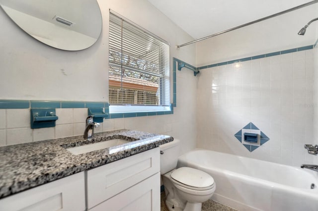 full bathroom featuring tile walls, visible vents, shower / bathing tub combination, toilet, and vanity