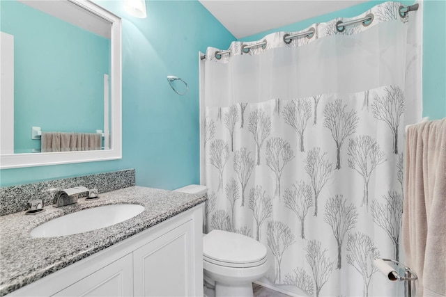 full bath featuring toilet, a shower with shower curtain, and vanity