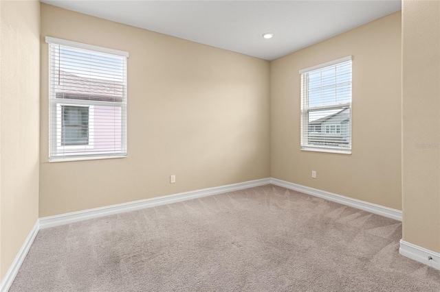 empty room featuring recessed lighting, carpet flooring, and baseboards