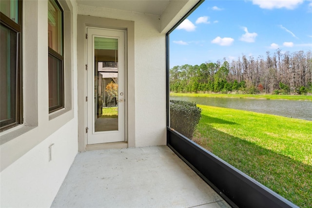 unfurnished sunroom with a water view