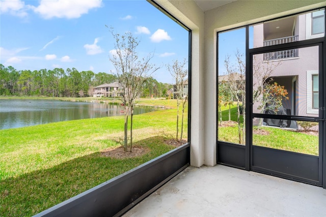 unfurnished sunroom featuring a water view and a healthy amount of sunlight