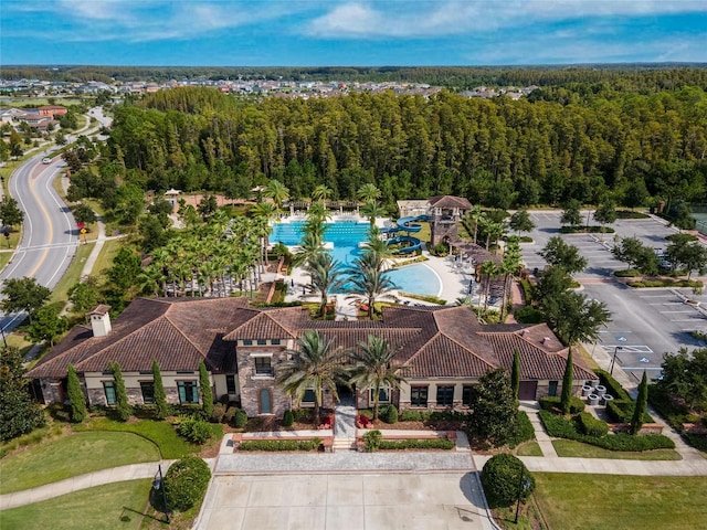 birds eye view of property with a forest view