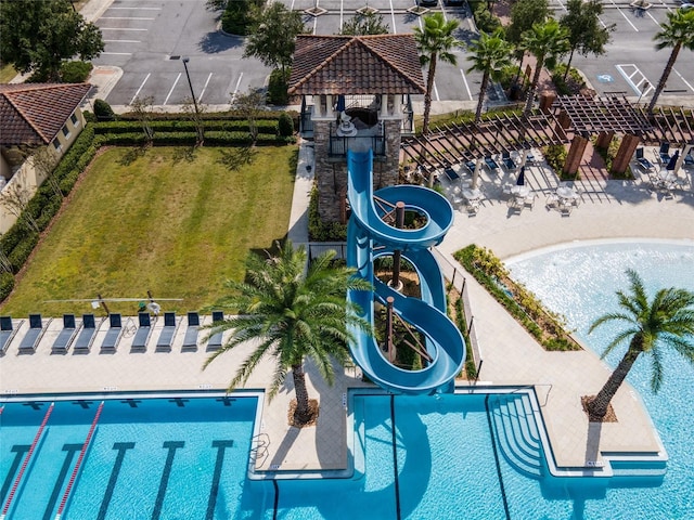 view of swimming pool with a yard