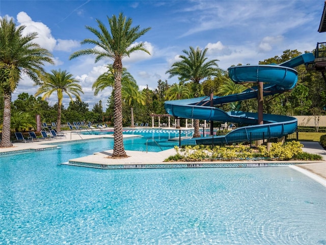 pool featuring a patio area and a water slide