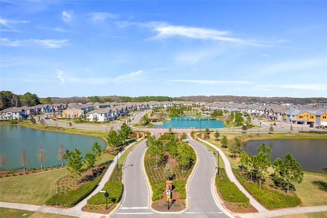 drone / aerial view with a water view and a residential view