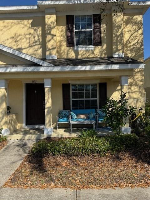 view of front facade with a porch and stucco siding