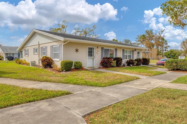 ranch-style home featuring central air condition unit, a front lawn, and stucco siding