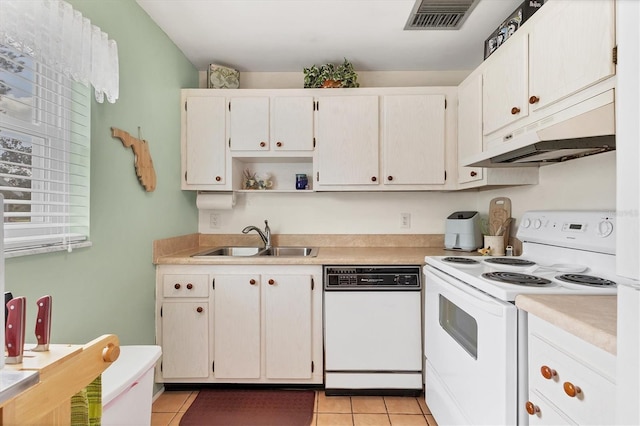 kitchen with visible vents, a sink, under cabinet range hood, white appliances, and light countertops