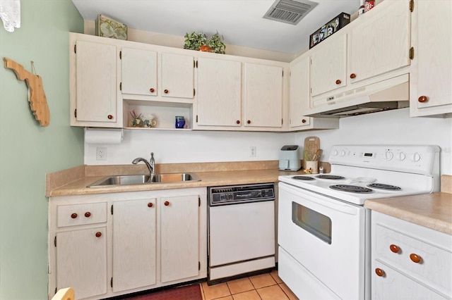 kitchen featuring white appliances, visible vents, a sink, light countertops, and under cabinet range hood