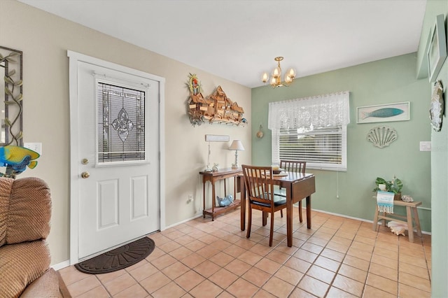 dining room featuring a notable chandelier, light tile patterned flooring, and baseboards