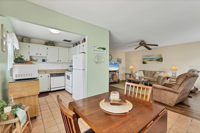 dining area featuring light tile patterned flooring, visible vents, and a ceiling fan