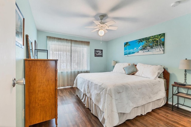 bedroom with ceiling fan, baseboards, and wood finished floors