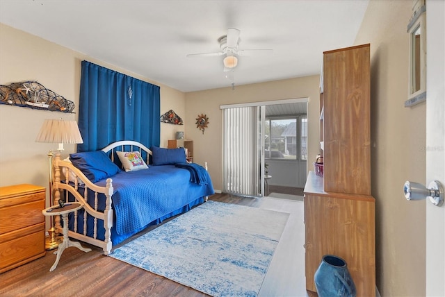 bedroom featuring access to outside, ceiling fan, and wood finished floors