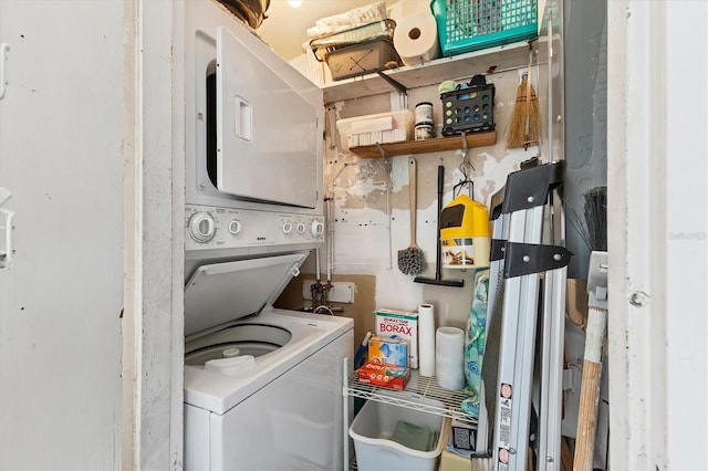 laundry area featuring stacked washer and clothes dryer and laundry area