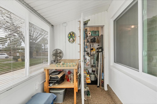 sunroom with a healthy amount of sunlight and vaulted ceiling