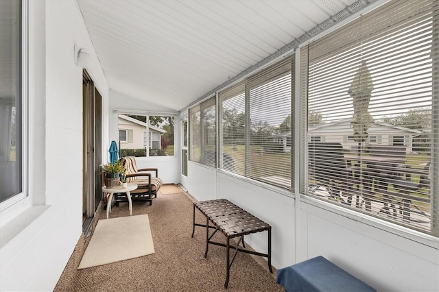 sunroom / solarium featuring vaulted ceiling