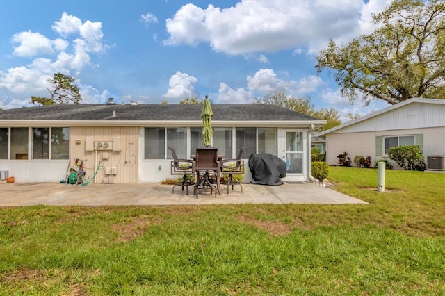 back of house featuring a yard, a patio, cooling unit, and a sunroom