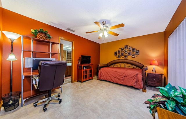 bedroom featuring a ceiling fan, visible vents, and ensuite bath