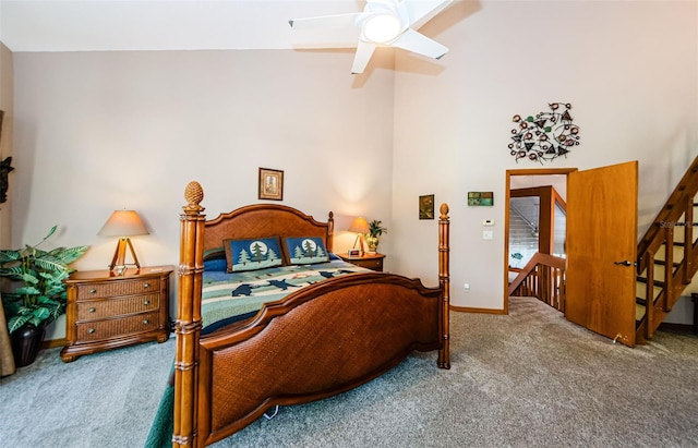 bedroom with carpet, a high ceiling, baseboards, and ceiling fan