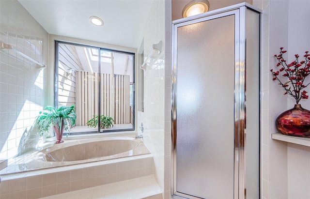 full bathroom featuring a stall shower and a garden tub