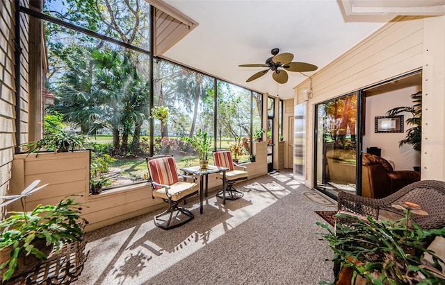 sunroom / solarium with a ceiling fan