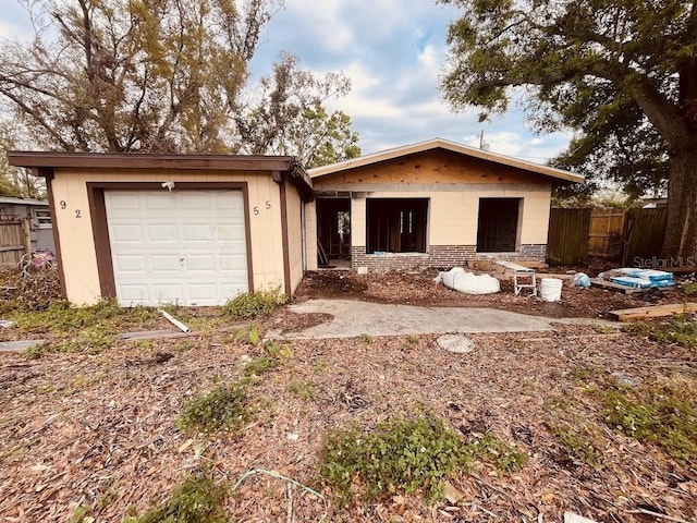 view of front facade with fence and an attached garage