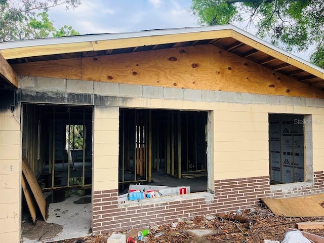 view of side of property featuring brick siding