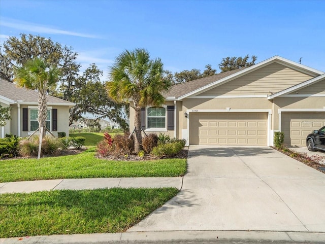 ranch-style home featuring a garage, a front lawn, concrete driveway, and stucco siding