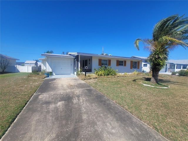 ranch-style home with a garage, driveway, fence, and a front lawn