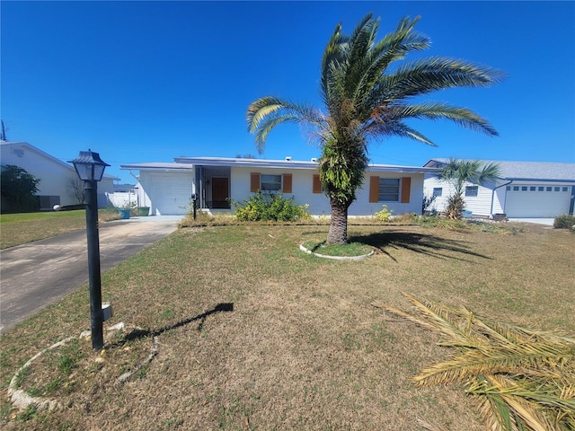 ranch-style home featuring a garage, central AC, driveway, and a front lawn