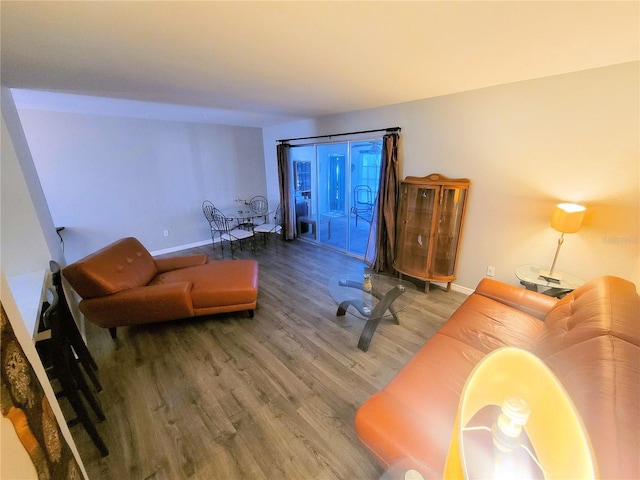 living room featuring baseboards and wood finished floors