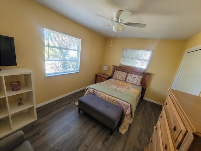 bedroom with dark wood-style floors, baseboards, and a ceiling fan