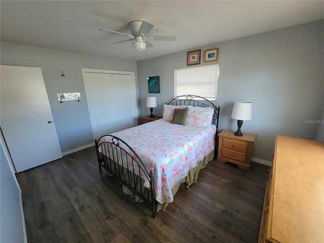 bedroom featuring a closet, dark wood finished floors, baseboards, and ceiling fan