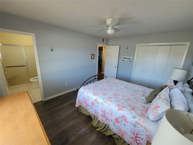 bedroom featuring a closet, visible vents, connected bathroom, wood finished floors, and baseboards