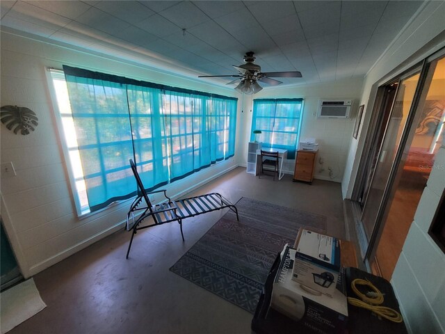 sunroom featuring ceiling fan and an AC wall unit