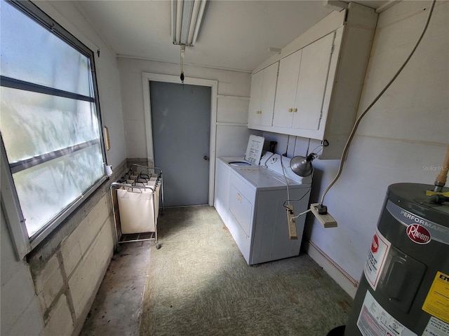 laundry area featuring washing machine and dryer, water heater, and cabinet space