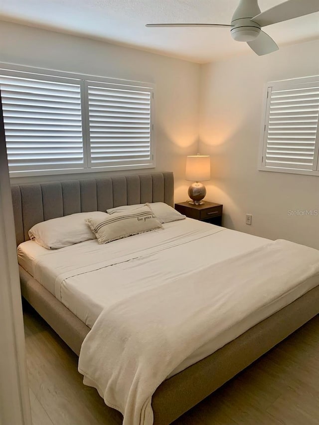 bedroom featuring a ceiling fan and wood finished floors