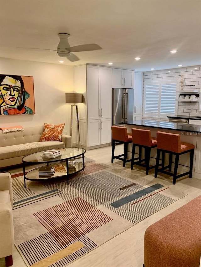 living room with ceiling fan and recessed lighting