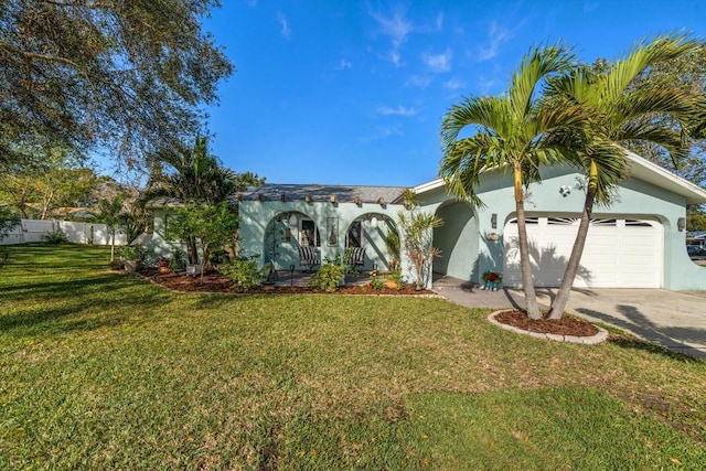 view of front of property featuring a garage, fence, concrete driveway, stucco siding, and a front yard