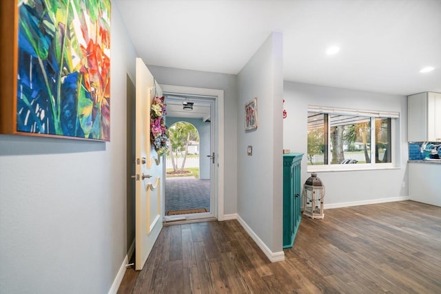 entryway with recessed lighting, dark wood-style flooring, plenty of natural light, and baseboards